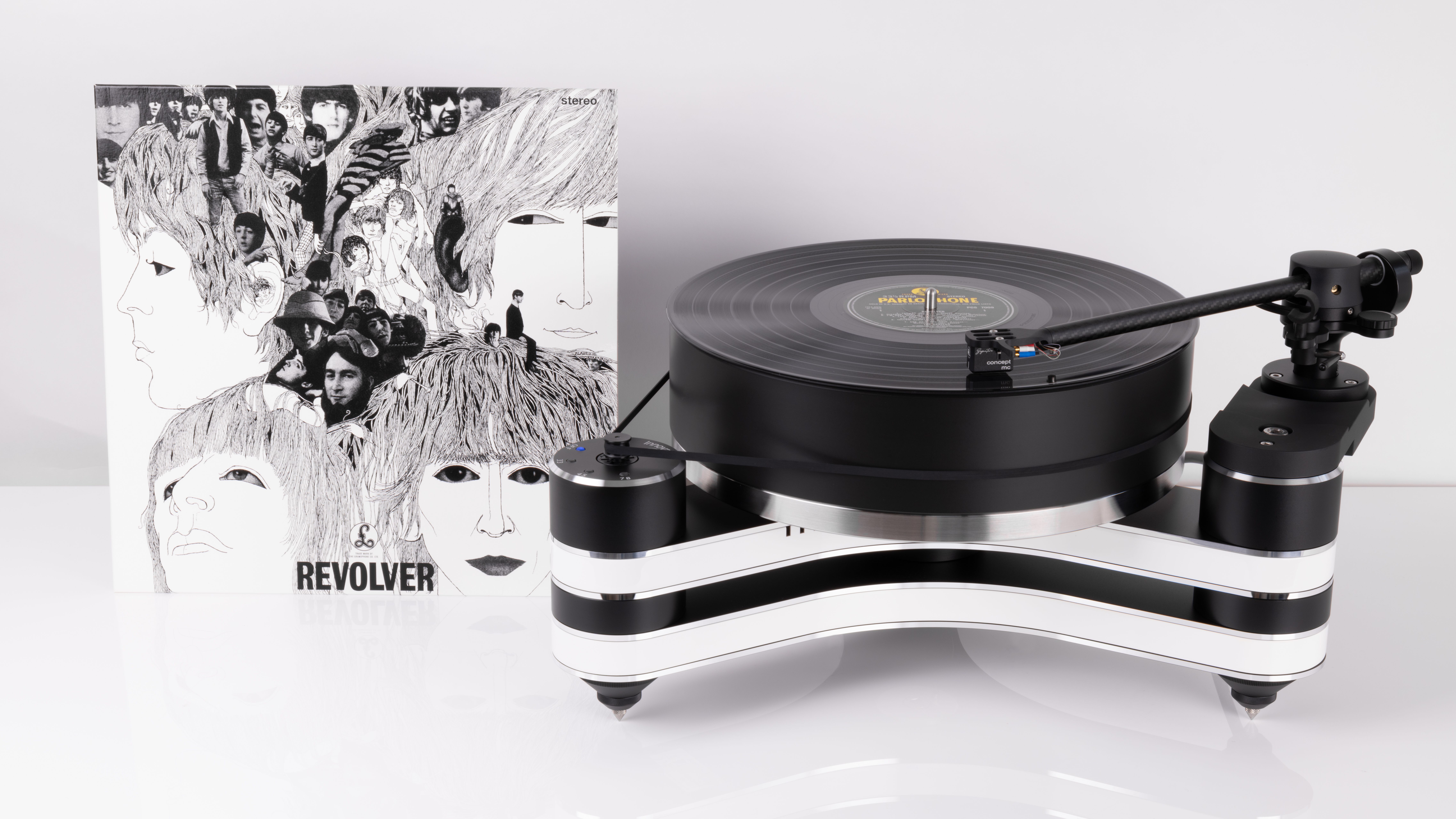 Clearaudio Innovation Revolver Beatles tribute turntable, with vinyl album in shot, on white background