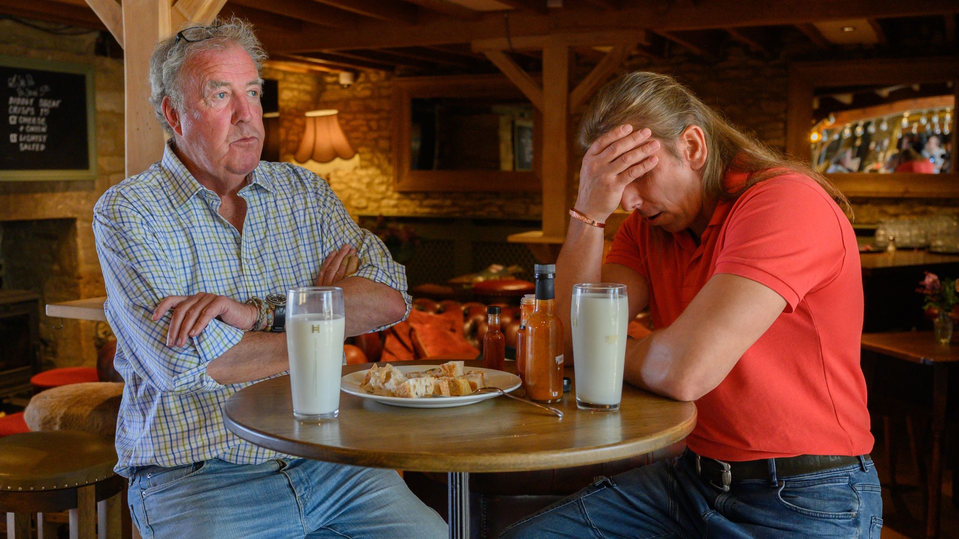 Jeremy Clarkson crosses his arms while a pub diner has his head in his hands.