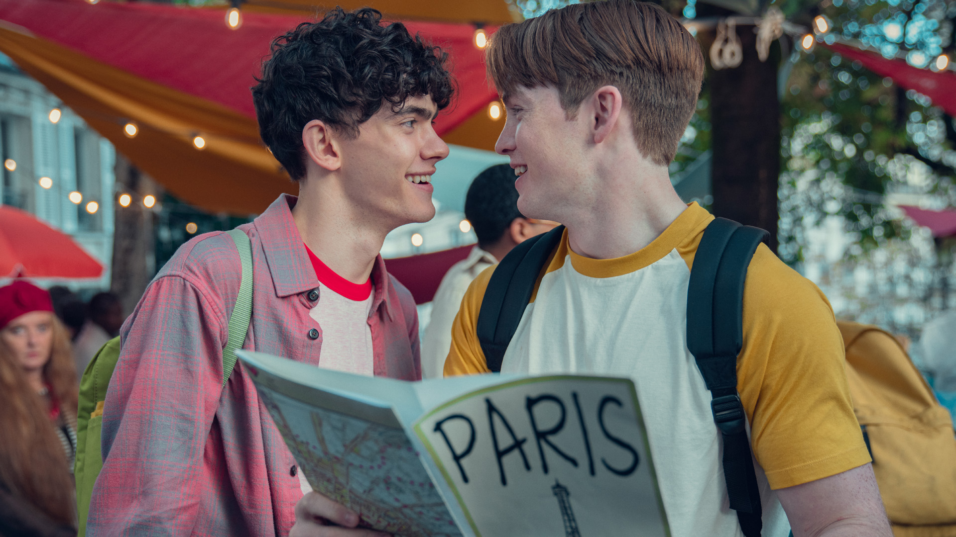Charlie and Nick smile and look at each other in season two of Heartstopper.