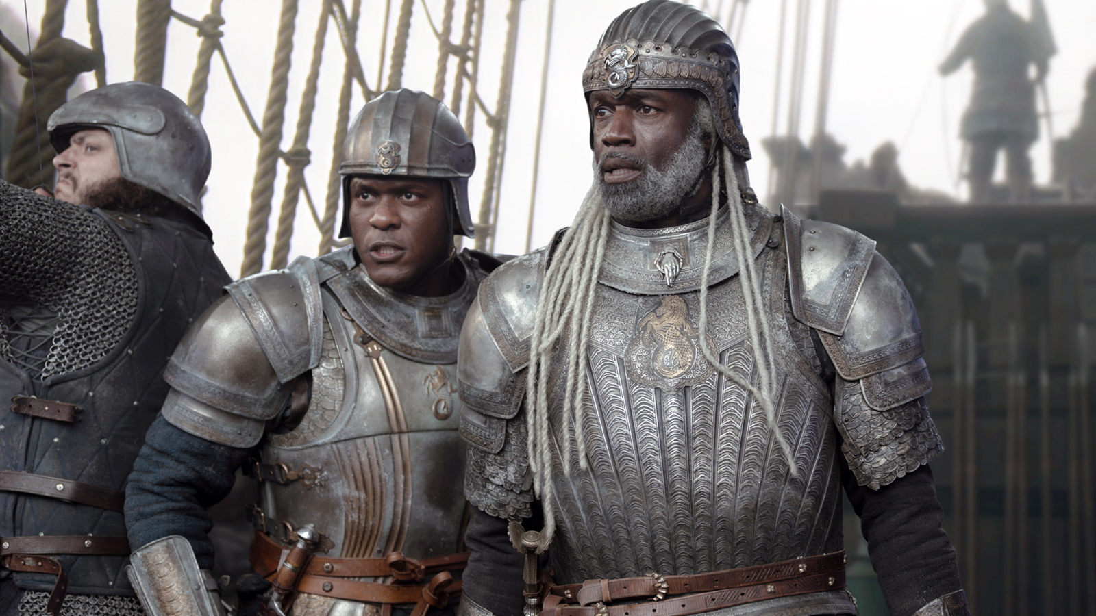 Alyn and Corlys look at something off camera while standing on the deck of a ship in House of the Dragon Season 3 Episode 1.