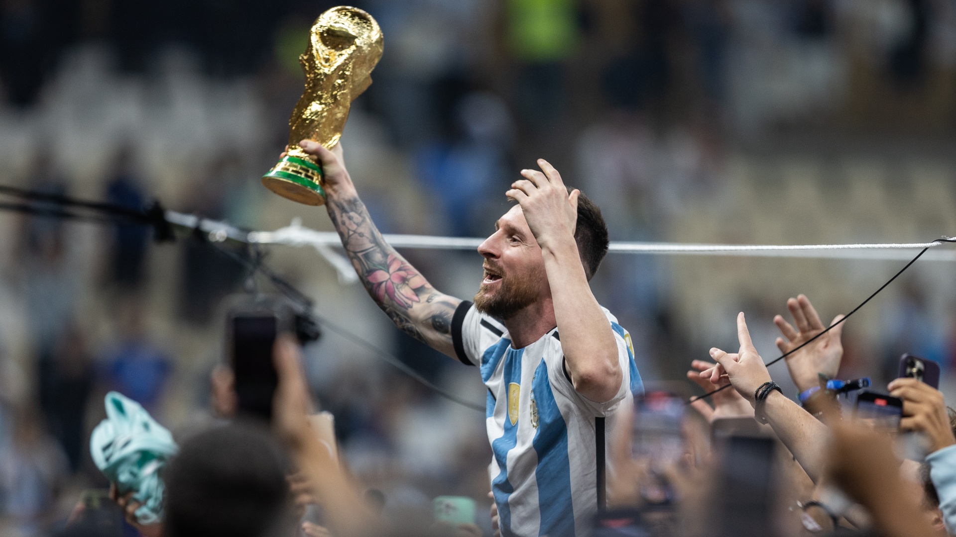 Lionel Messi of Argentina celebrating with the 2022 FIFA World Cup trophy