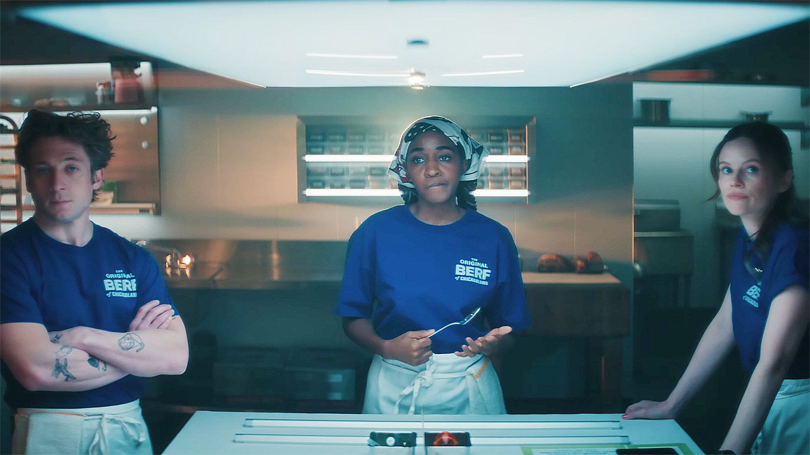 Carmy, Sydney and Jessica looking at something off camera in season 5 of The Bear