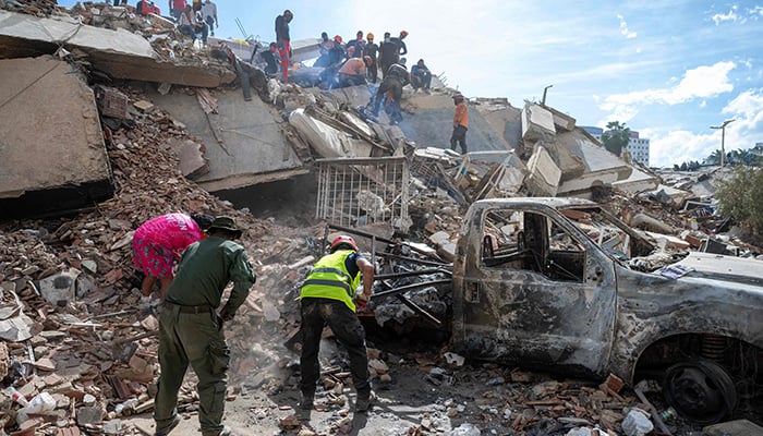Rescuers and volunteers search for survivors in the rubble of a collapsed building in La Guaira state, Venezuela, on June 28, 2026, following the earthquakes. — AFP