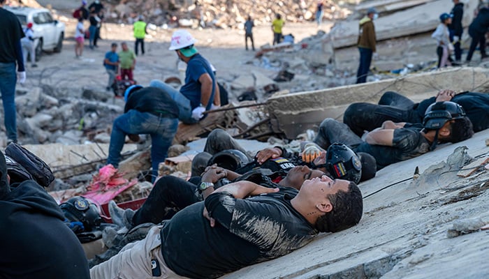 Rescuers and volunteers rest on the rubble of collapsed buildings in Caraballeda, La Guaira state, Venezuela, on June 28, 2026, following the earthquakes. — AFP