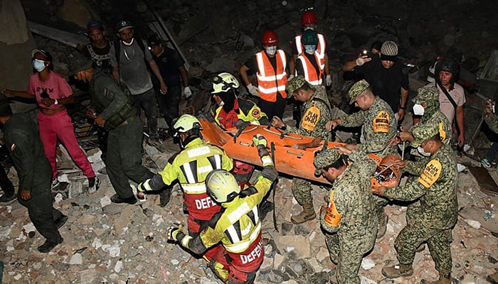 A photograph released by the Mexican army shows the rescue of a nine-year-old boy in an area affected by two earthquakes in the state of La Guaira, Venezuela, on June 28, 2026. — AFP