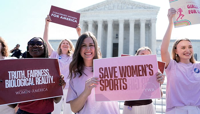Women hold signs as they celebrate the US Supreme Court's final rulings of its nine-month term, including a decision that paved the way for states to impose restrictions on transgender student athletes, in Washington, DC, United States, on June 30, 2026. – Reuters