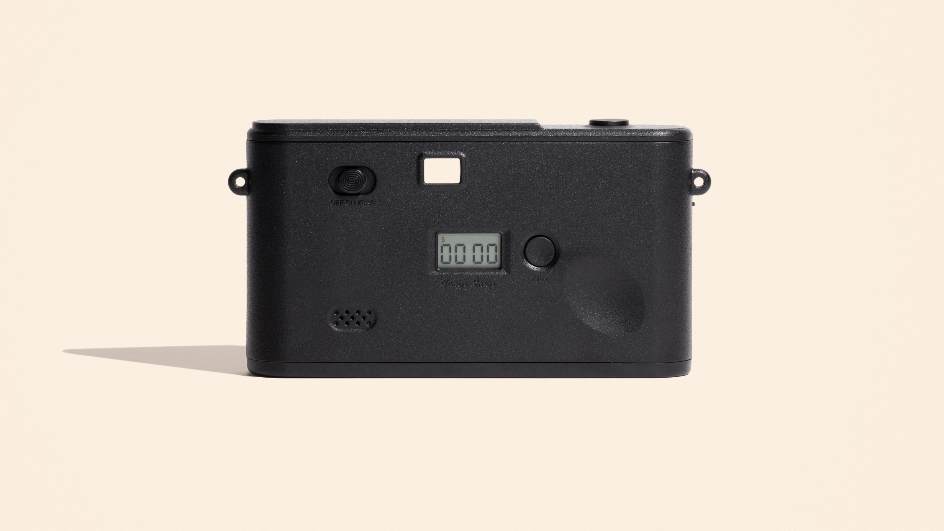 Photograph of the small Camp Snap 2 compact digital camera with white back, showing the back without a screen and with only a shot counter.