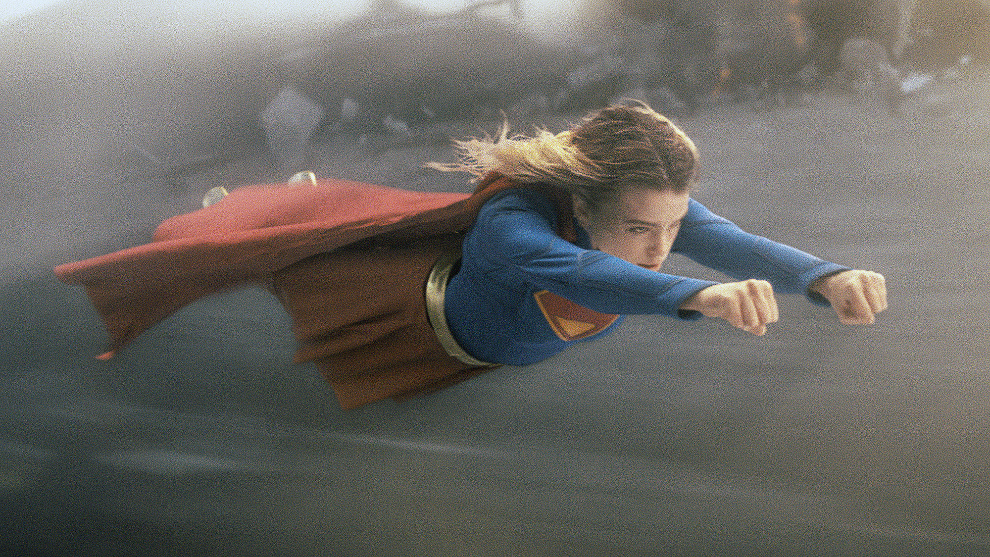 Milly Alcock's Kara Zor-El in her classic superhero costume as she flies through the air in the 2026 Supergirl movie