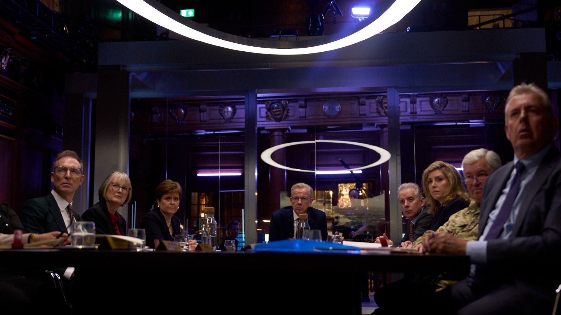 A fake government cabinet sitting around a conference table