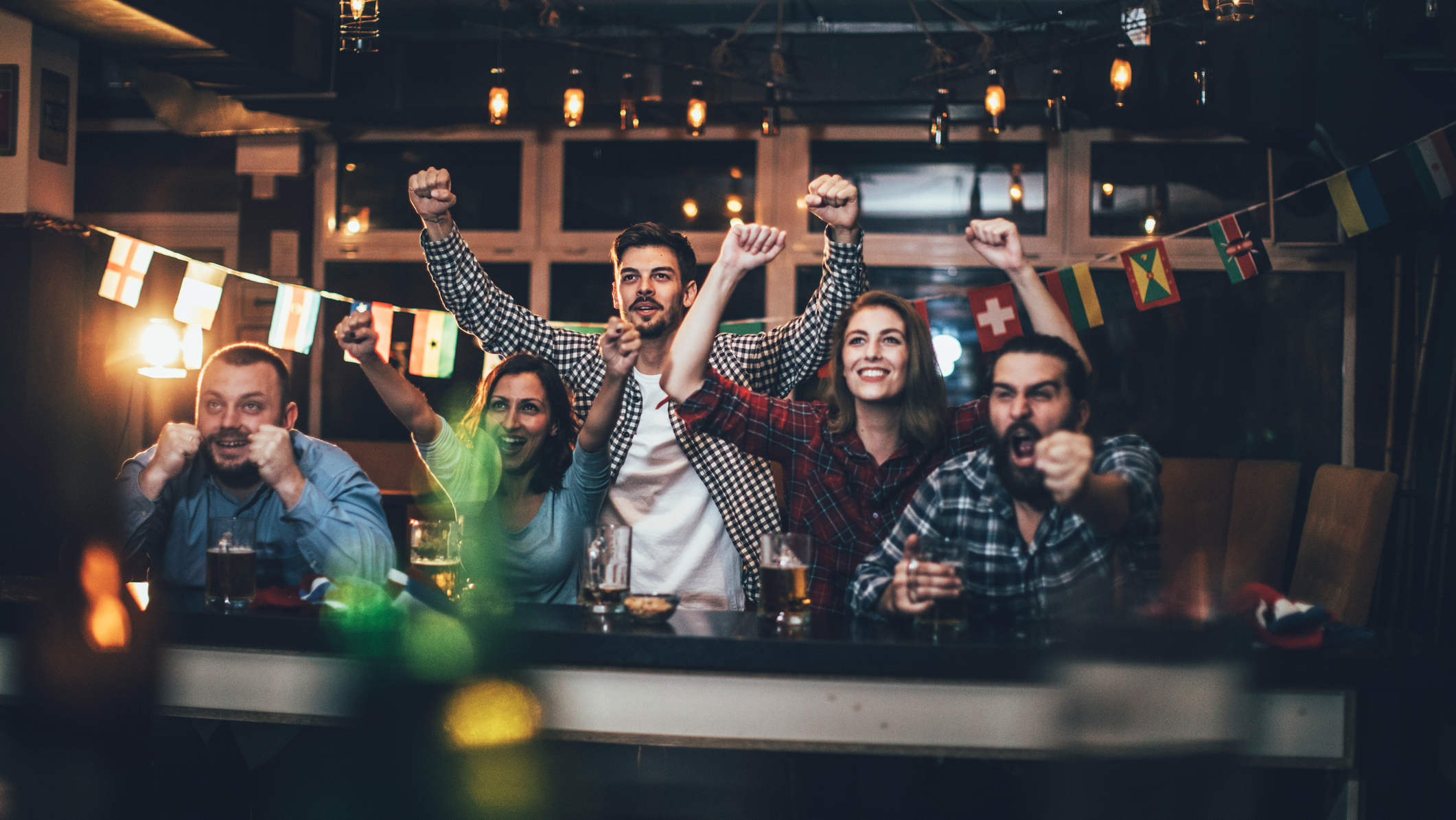 A crowd enthusiastically watching a television event.