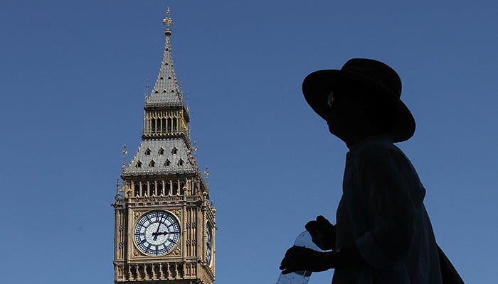 A person holds a bottle of water as he walks near Big Ben and the Houses of Parliament, in London, Britain, June 23, 2026. – Reuters