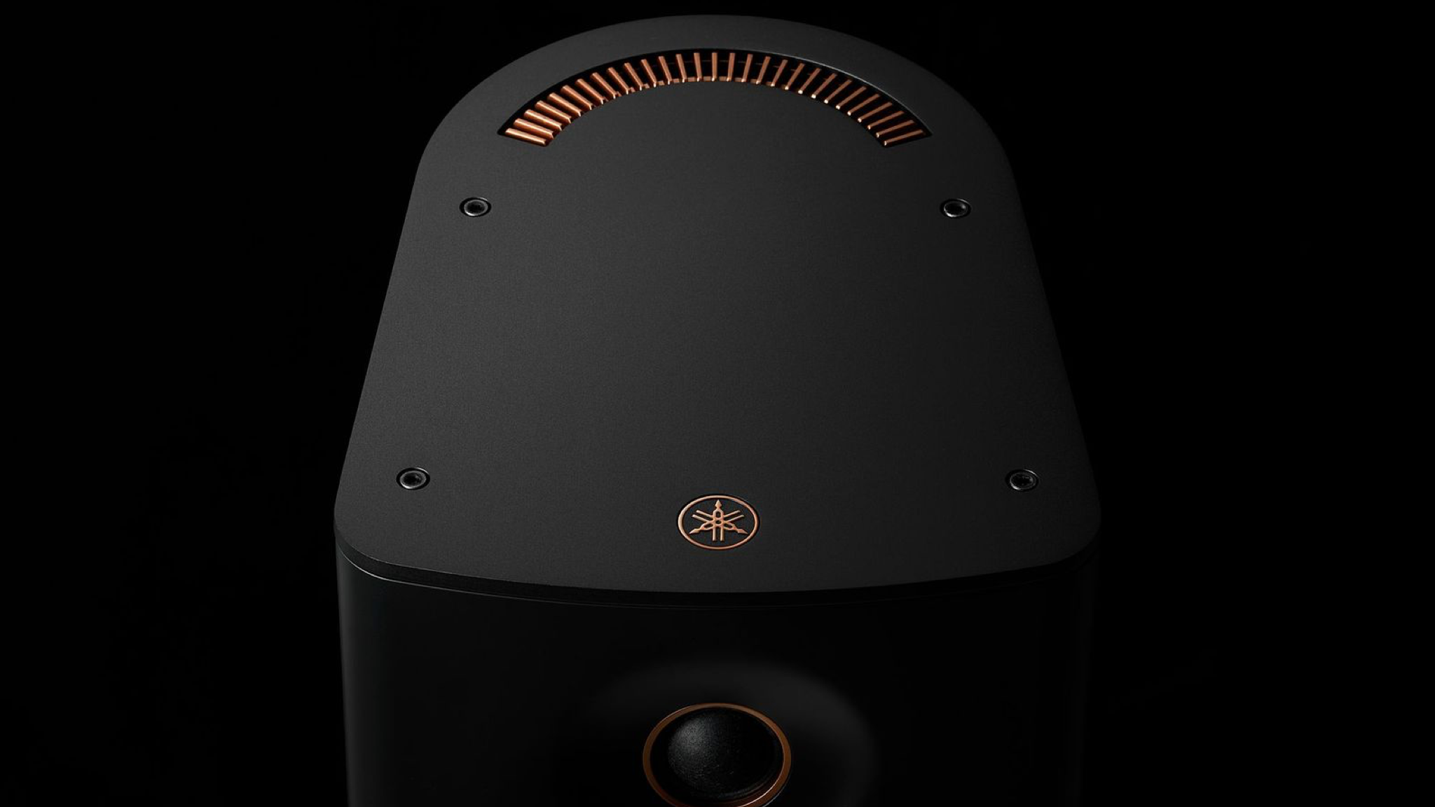 Close-up of the Yamaha NX-70A speaker in black, on a black background