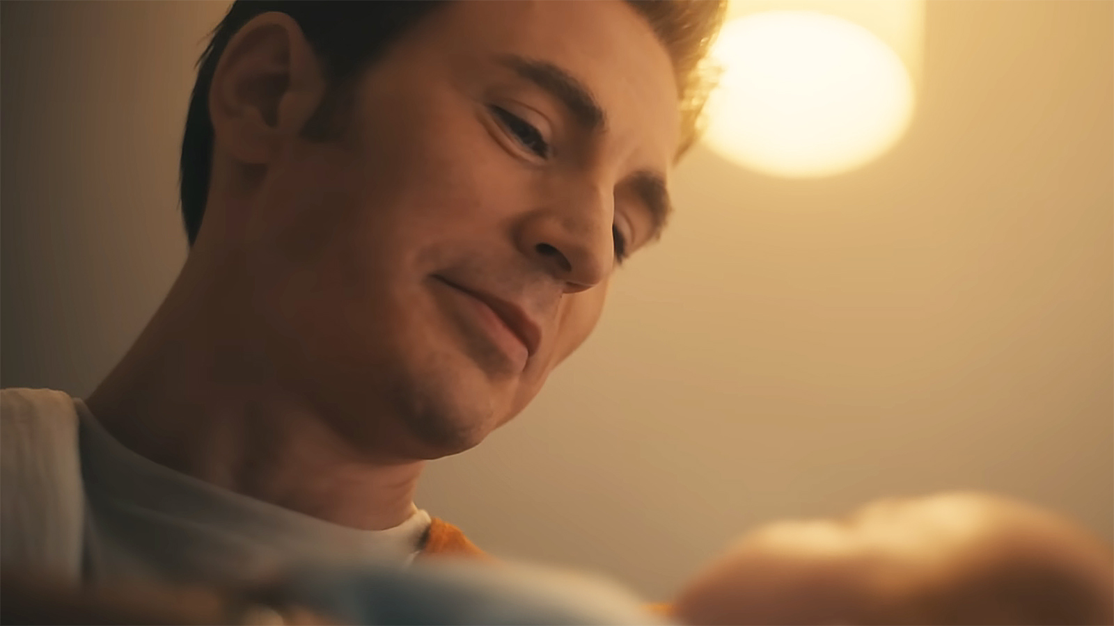 Steve Rogers smiling as he looks down at his newborn son in Avengers: Doomsday