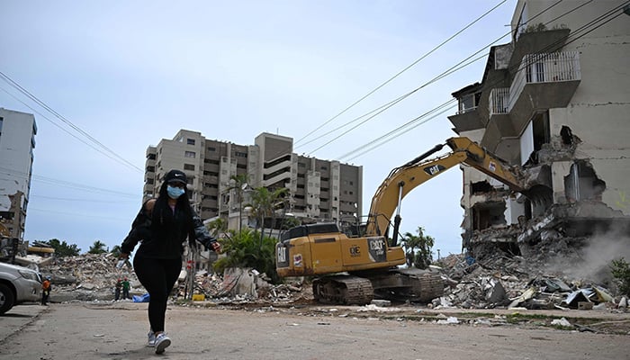 A backhoe demolishes a building in La Guaira, Venezuela, on July 4, 2026, following the twin earthquakes of June 24. — AFP