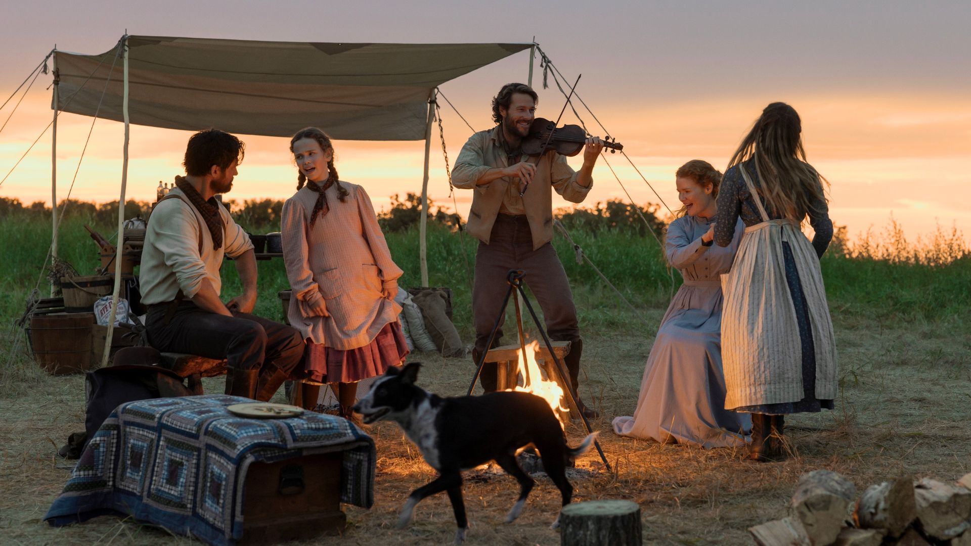 The Ingalls family dances while Charles plays the violin.