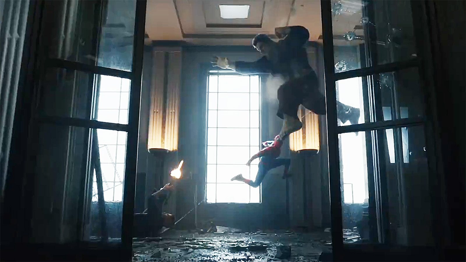 The Punisher lying on the ground while shooting Hulk in the air, towards whom Spider-Man jumps, in Spider-Man: Brand New Day
