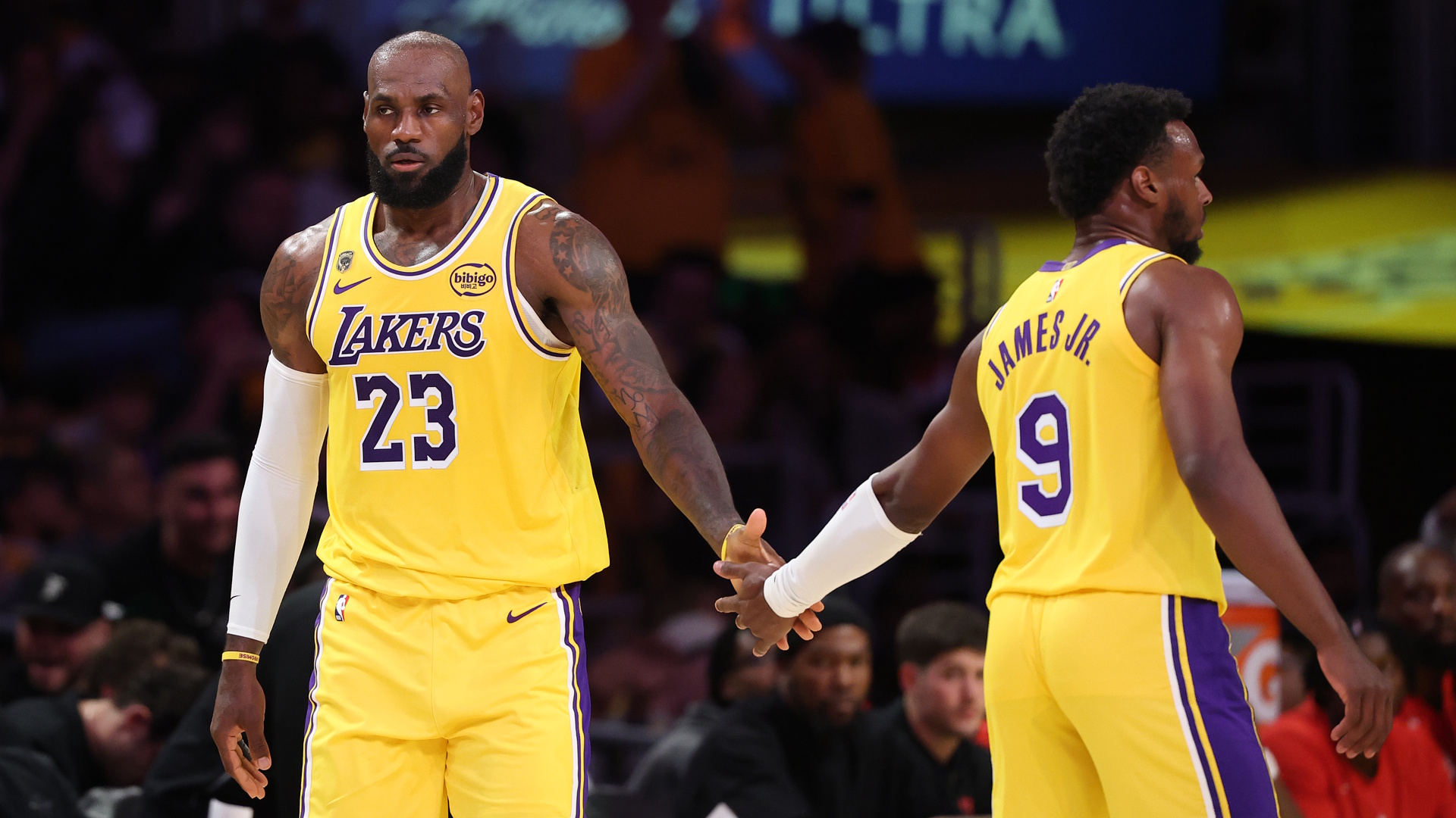 Los Angeles Lakers forward LeBron James is congratulated by his son and teammate, Lakers guard Bronny James, during a 2026 NBA Playoffs game.