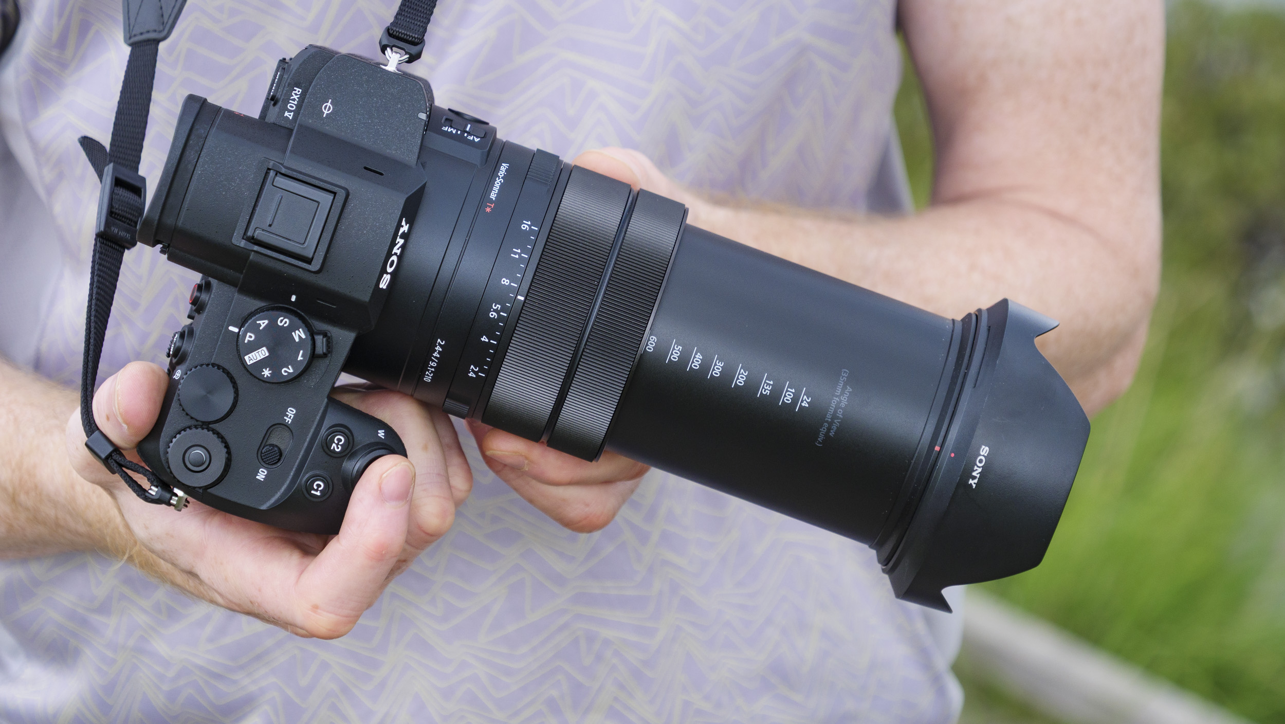 Technology photographer and journalist Tim Coleman holds the Sony RX10 V bridge camera, with the lens zoomed out