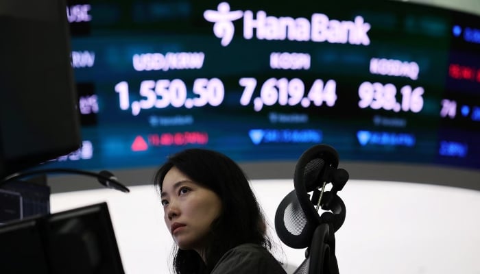 A foreign exchange trader works in front of an electronic board displaying the exchange rate between the U.S. dollar and the South Korean won, the Korea Composite Stock Price Index (KOSPI) and the South Korean won, and Korea Securities Dealers Automated Quotes (KOSDAQ) in the trading room of a bank in Seoul, South Korea, June 8, 2026. – Reuters