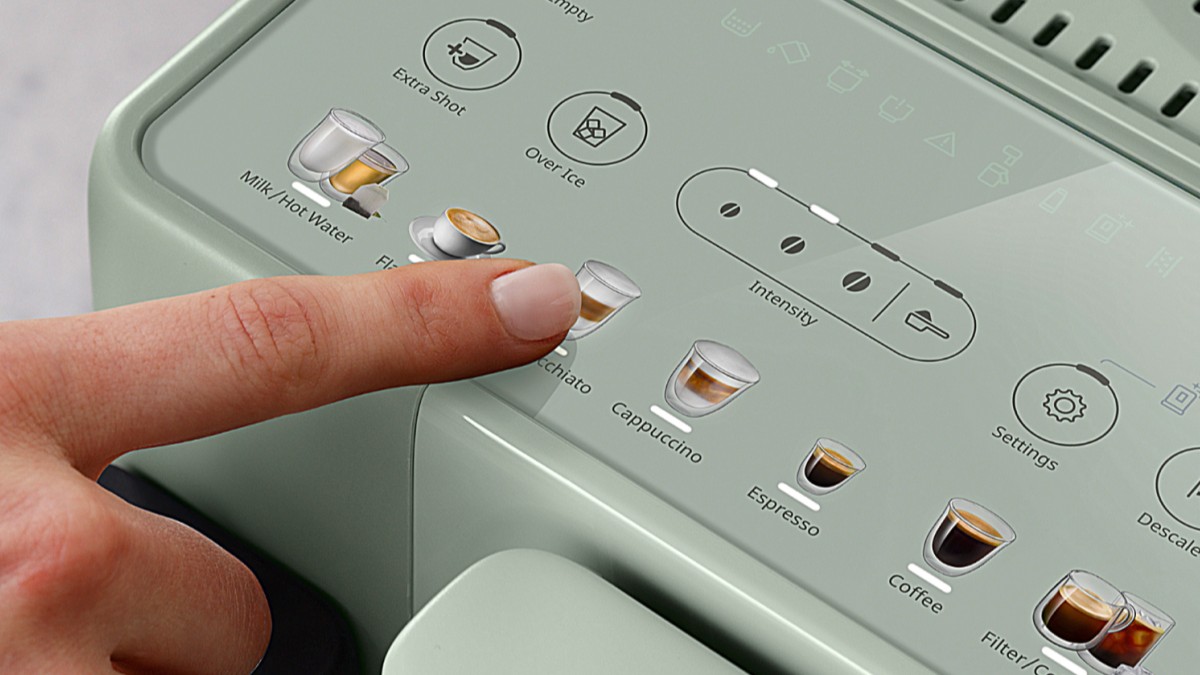 Person pressing the button on the De'Longhi Rivelia Start coffee machine