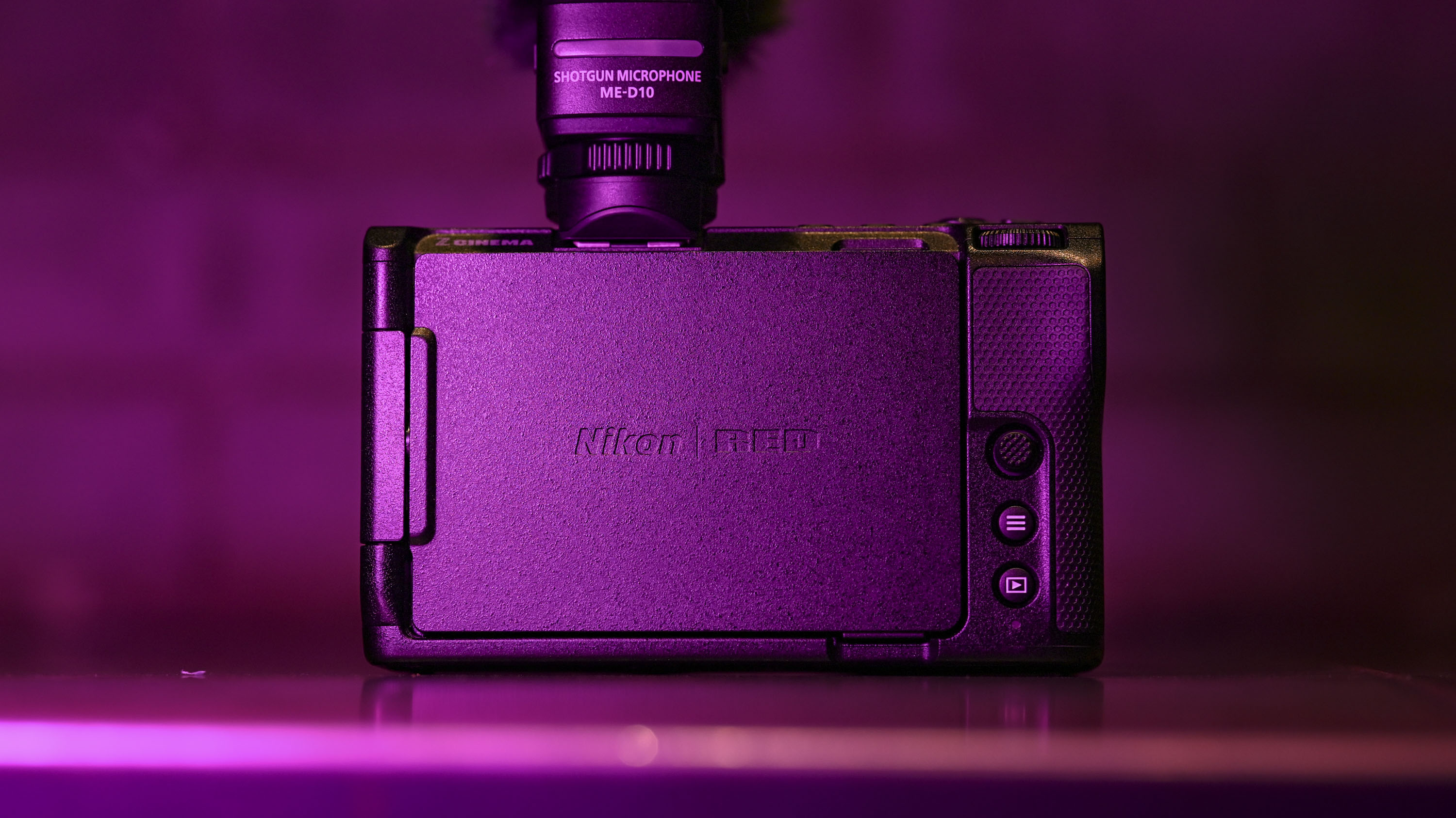 Back of Nikon ZR camera under low-key magenta lighting