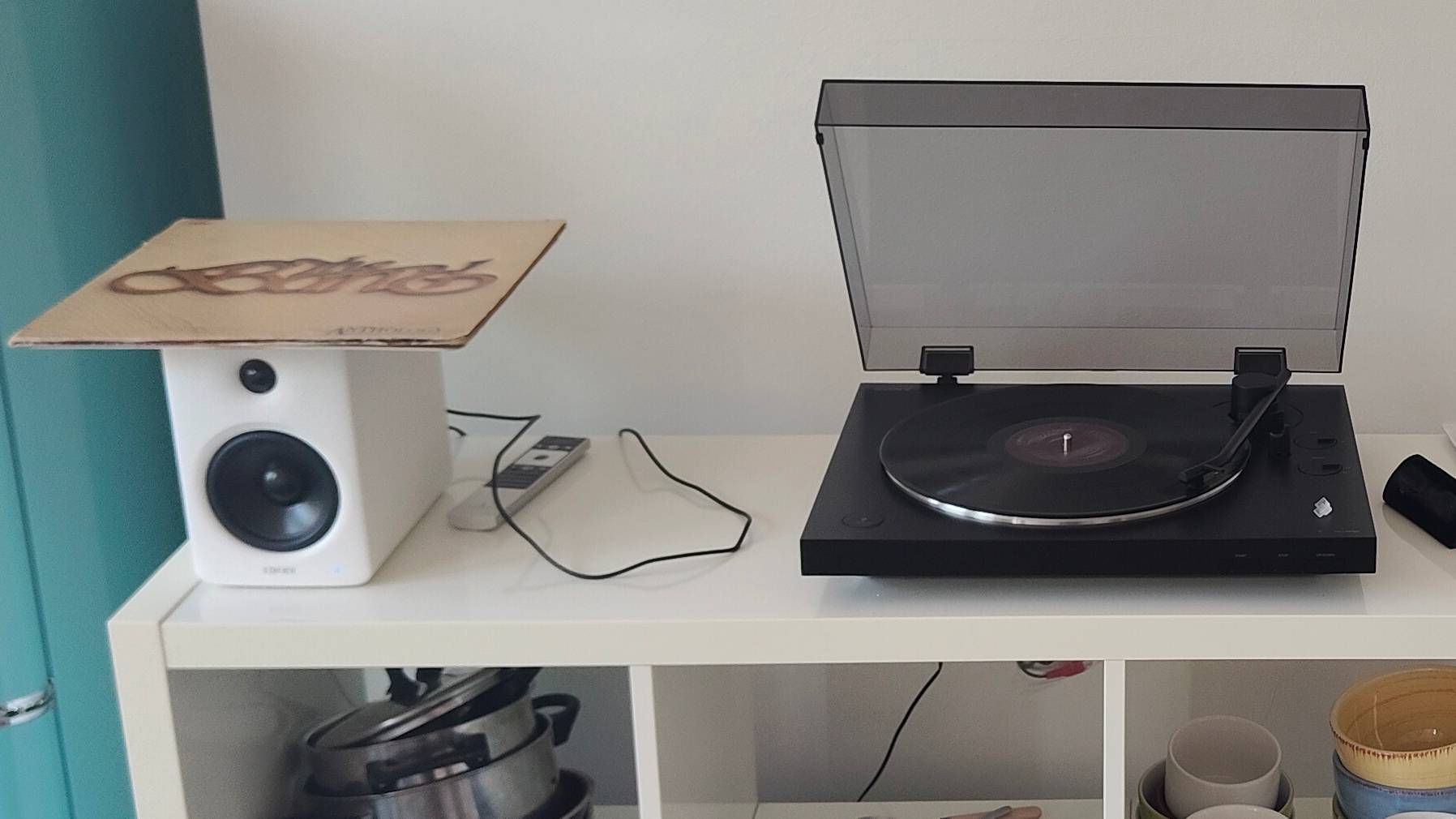 The Sony PS-LX310BT and the Edifier M90 on a shelf.